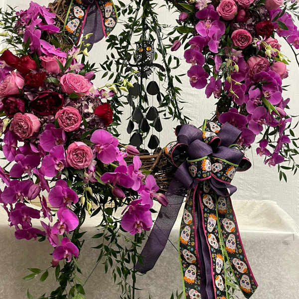 Purple orchid and pink rose wreath with skull ribbons