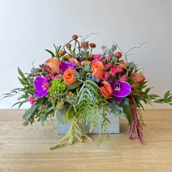 Bright mixed flower arrangement in a rectangular container