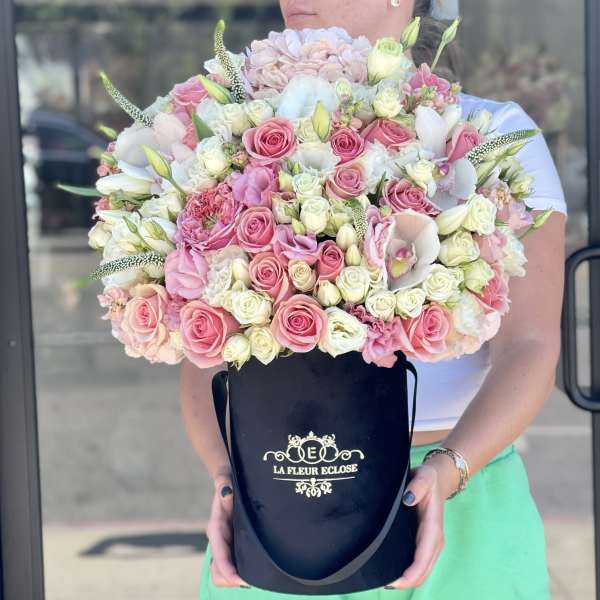 Large pink and white rose bouquet in a black hat box