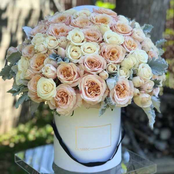 Peach and cream rose bouquet in a white hat box