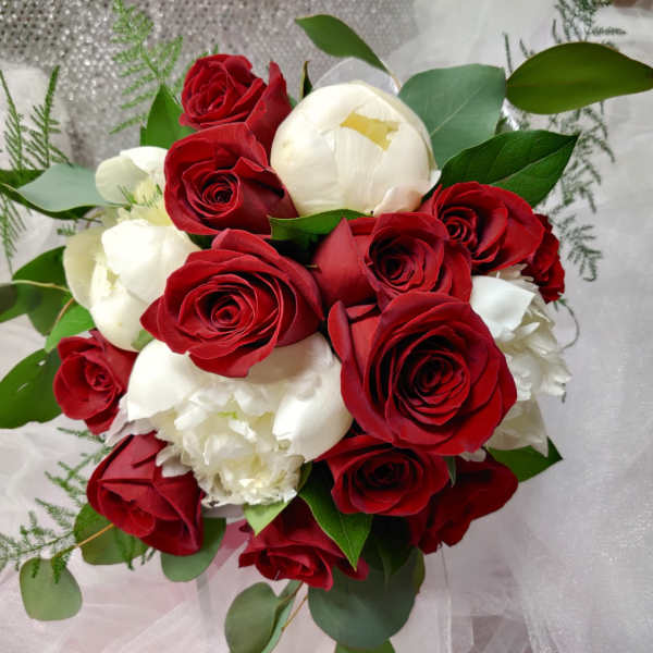 Bouquet of red and white roses with greenery