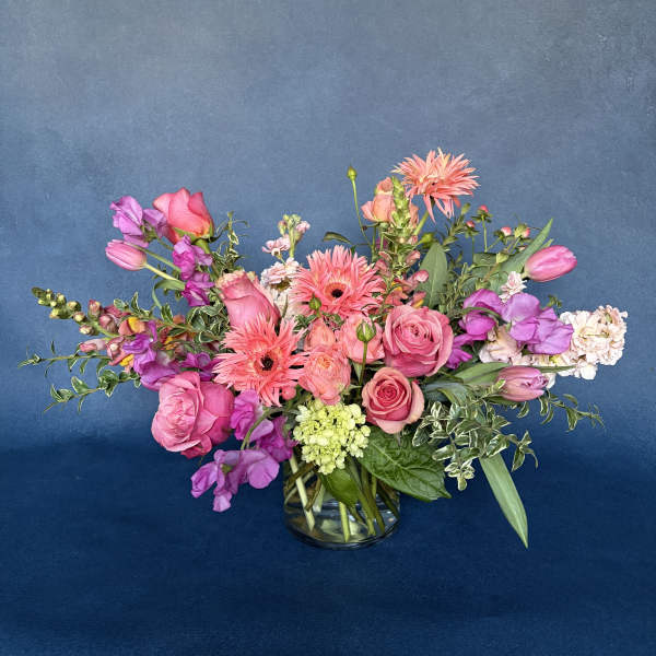 Pink and purple mixed bouquet in a clear glass vase