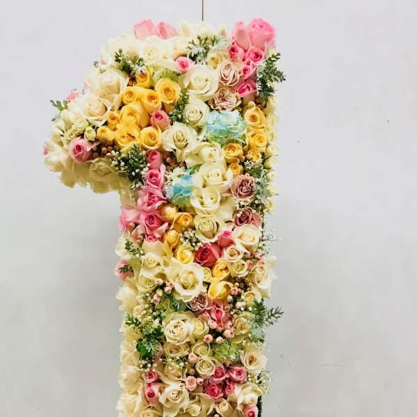 Large floral number one made of pastel roses and hydrangeas