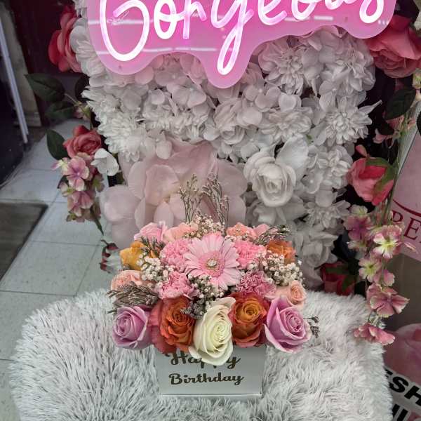 Compact pink and peach rose and gerbera arrangement in a white Happy Birthday box.