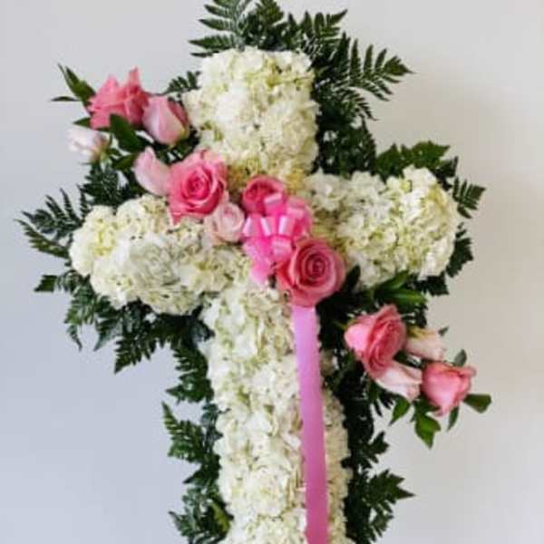 White floral standing spray with pink roses and ribbon
