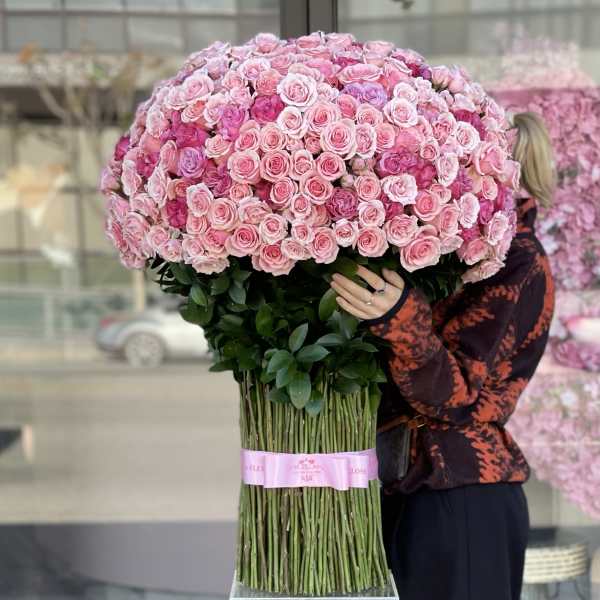 Large bouquet of pink roses held by a person