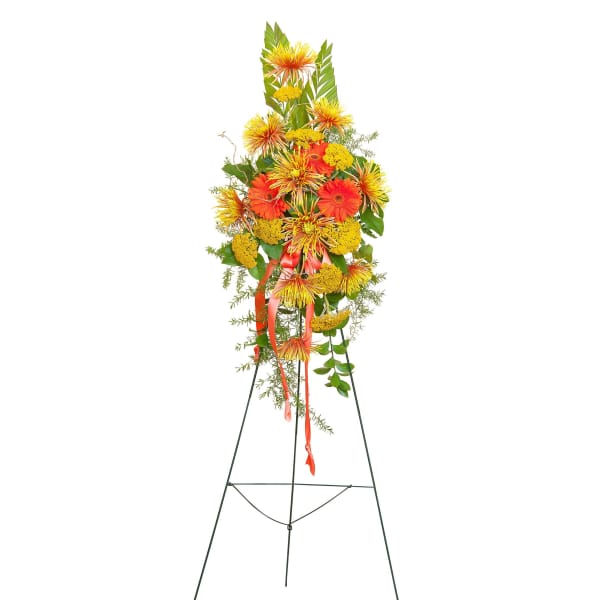 Tall standing spray of yellow and orange flowers on a metal easel
