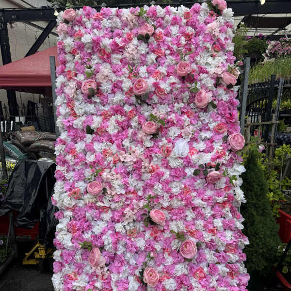 Pink and white floral wall with scattered roses