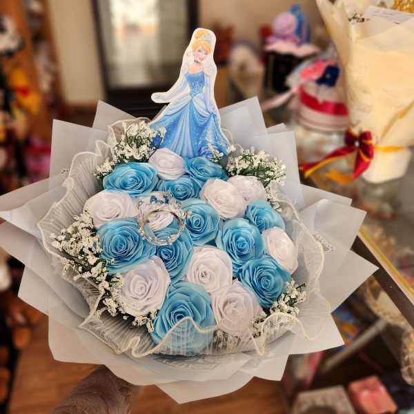 Blue and white rose bouquet with a princess topper