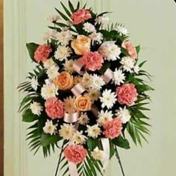 Standing floral spray with pink and white flowers on an easel