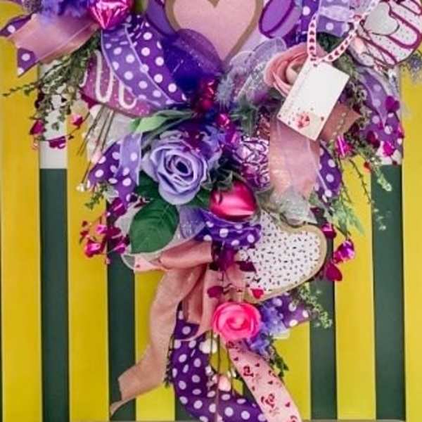 Unicorn-themed bouquet with pink and purple flowers, ribbons, and candy decorations