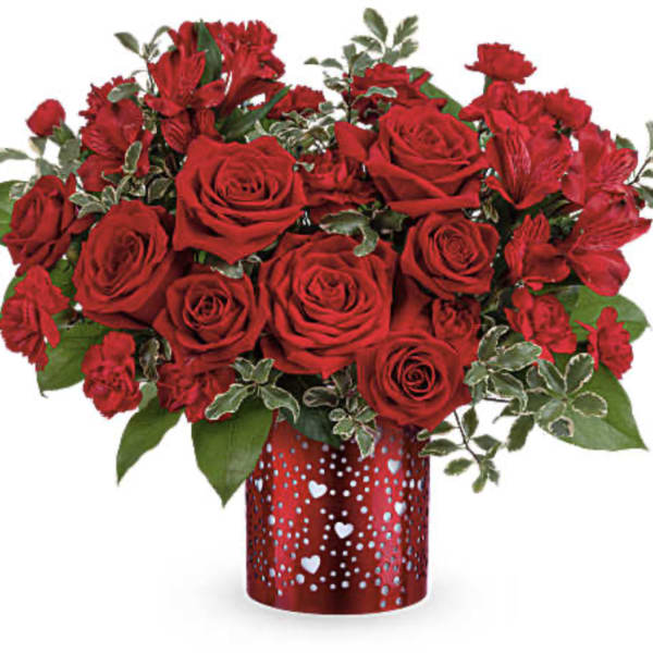 Red roses and red alstroemeria in a heart-patterned vase