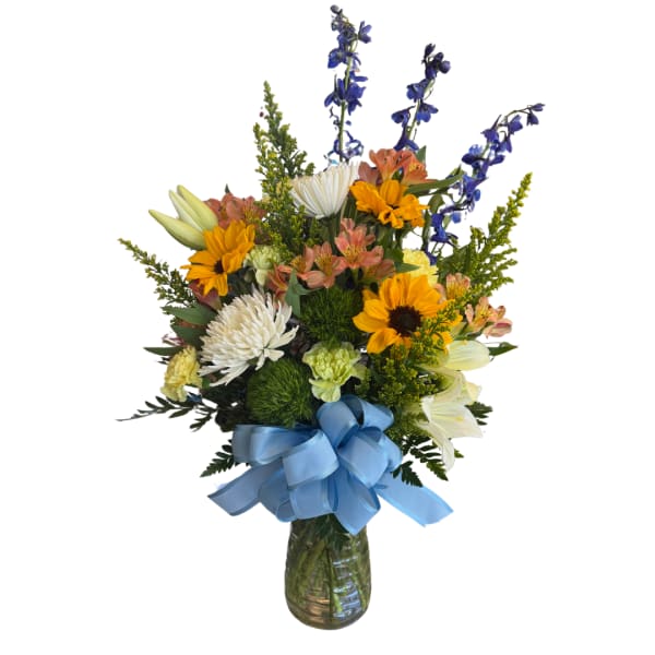 Mixed bouquet in a glass vase with a blue ribbon