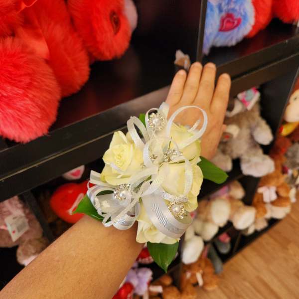 White rose wrist corsage with silver ribbon and rhinestone accents