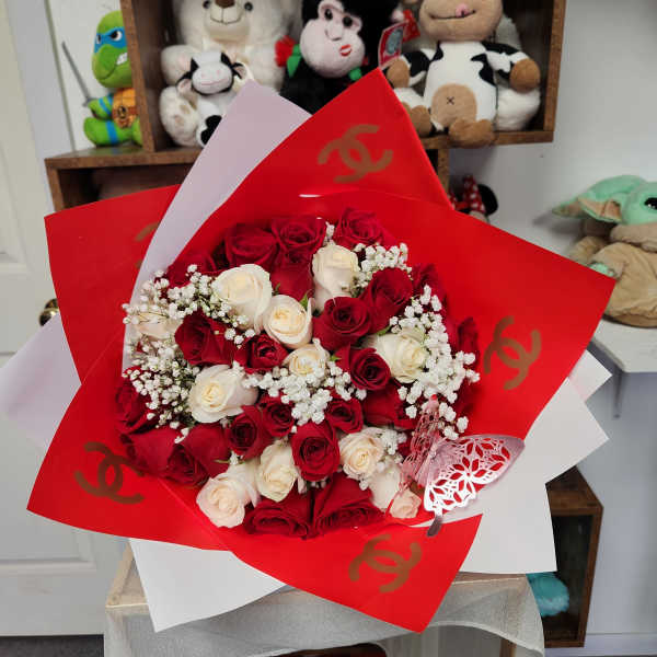 Bouquet of red and white roses wrapped in red paper
