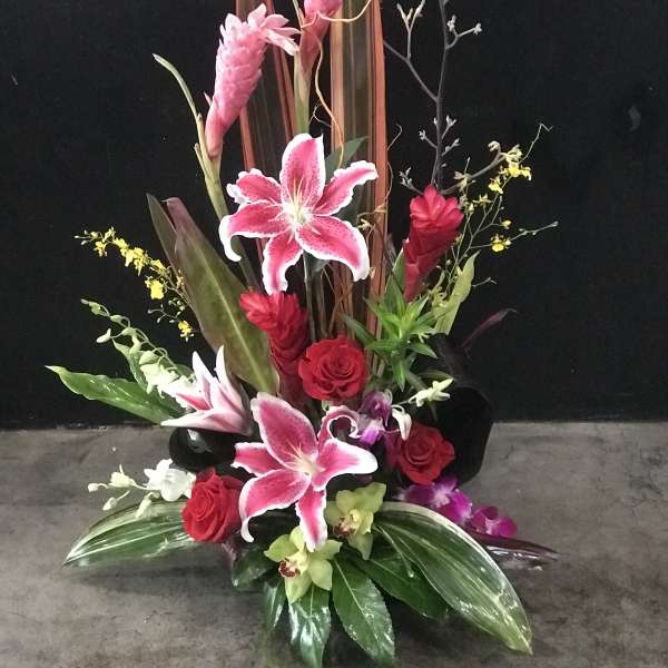 Tall tropical bouquet with pink lilies and red roses