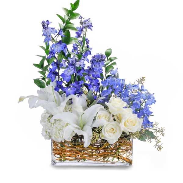 Blue and white floral arrangement in a rectangular glass vase