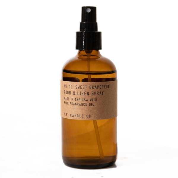 Amber spray bottle labeled sweet grapefruit room and linen spray