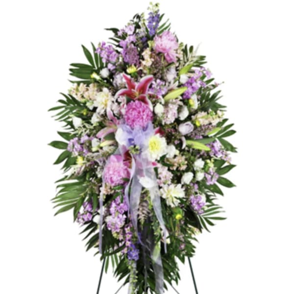 Standing floral spray with pink, purple, and white flowers on an easel