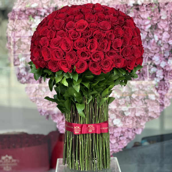 Large bouquet of red roses with long stems tied with a ribbon