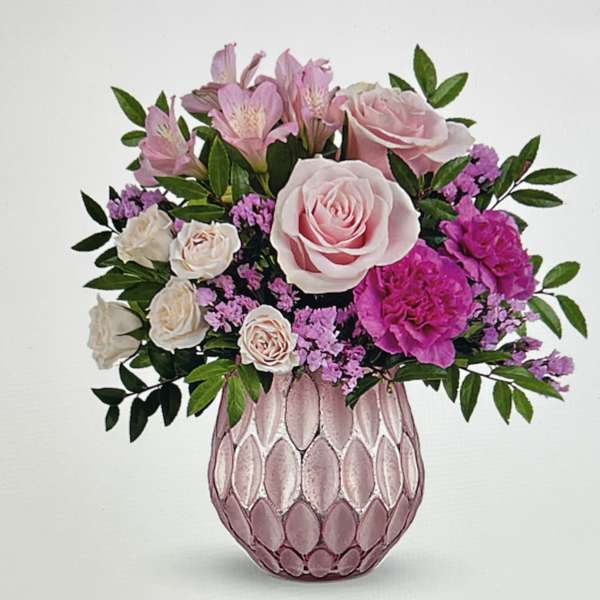 Pink and white flower arrangement in a textured pink vase