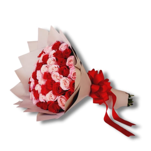 Wrapped bouquet of red and light pink roses with tan paper and a red ribbon bow