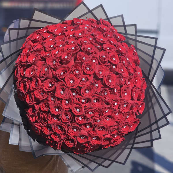 Large bouquet of red roses with clear gem accents and black wrap