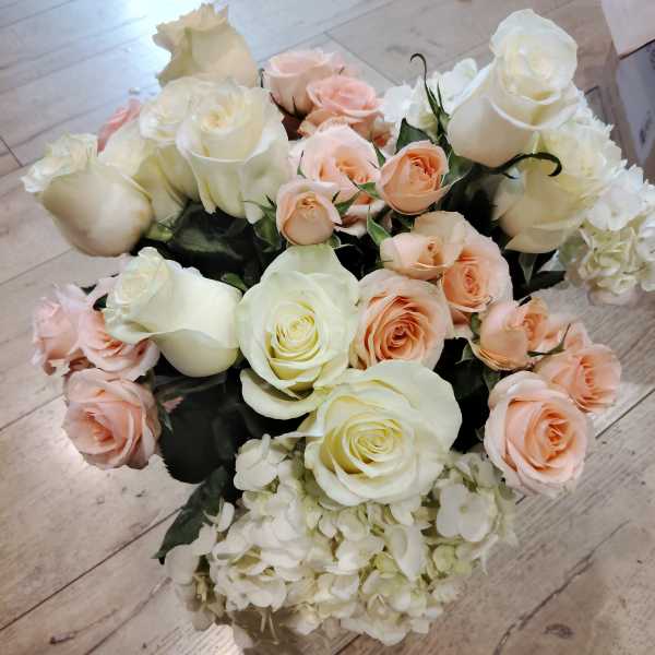 Bouquet of white and blush roses with white hydrangea