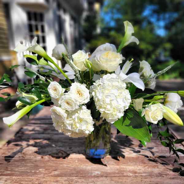 White floral arrangement in a clear glass vase