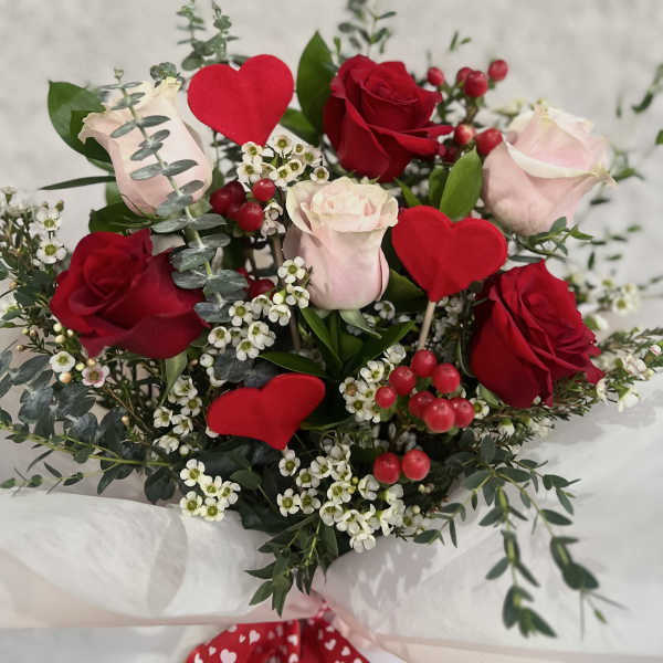 Bouquet of red and pale pink roses with red heart picks