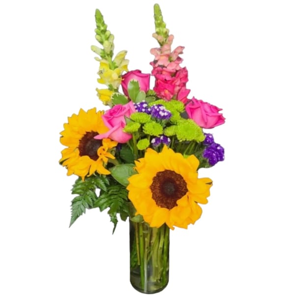 Bouquet of sunflowers, pink roses, and purple flowers in a glass vase