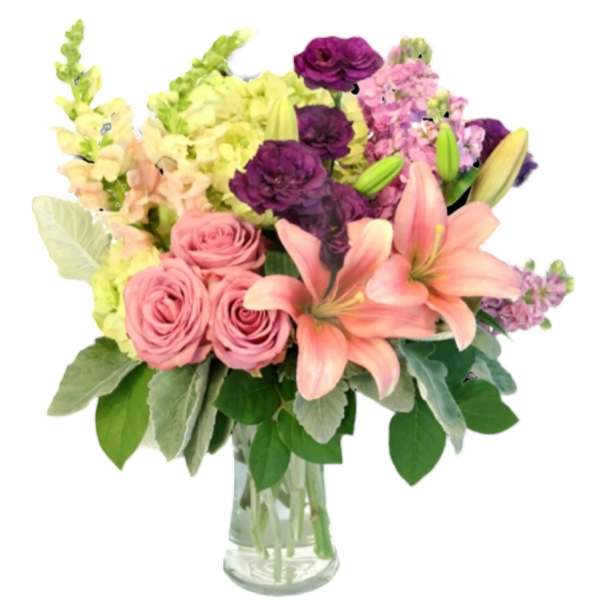 Pink roses and lilies in a clear glass vase with purple and yellow flowers