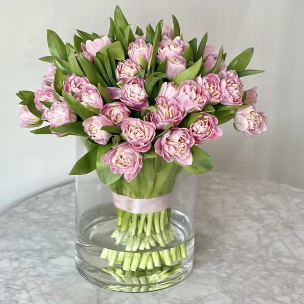 Pink tulip bouquet in a clear glass vase
