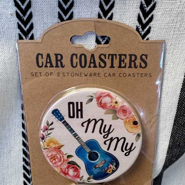 Packaged set of two round car coasters with floral guitar designs