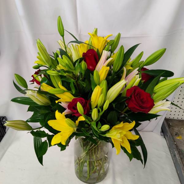 24 lilies 6 red roses on a vase
