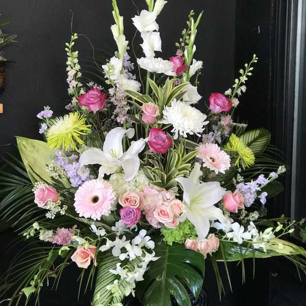 Large floral spray with white lilies, pink roses, and chrysanthemums