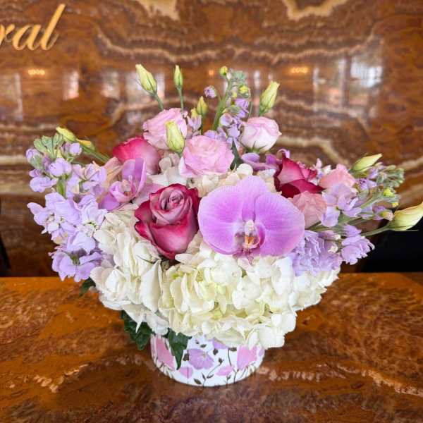 Pink and lavender bouquet with white hydrangeas in a floral box