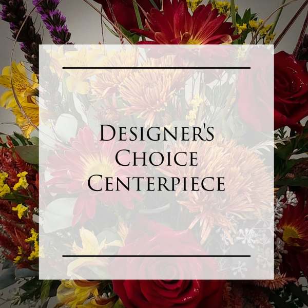 Designer’s choice centerpiece with red, yellow, and purple flowers
