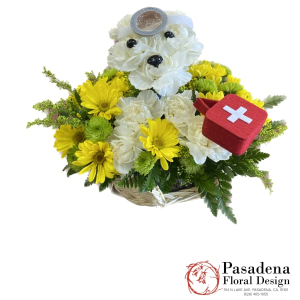 Yellow and white flower basket with a teddy bear and red first-aid kit