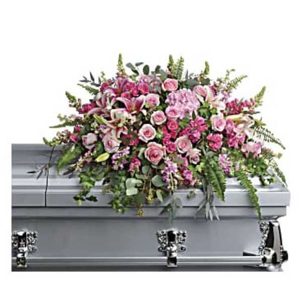 Pink floral spray on a silver casket