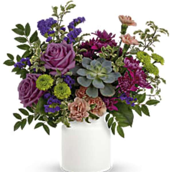 Mixed bouquet in a white vase with purple, pink, and green blooms
