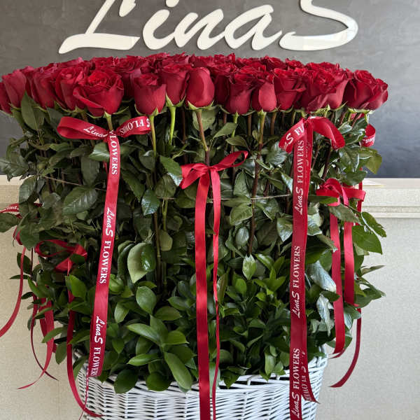 Large basket arrangement of red roses with red ribbons
