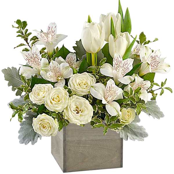White tulips and roses in a square wooden vase with green foliage