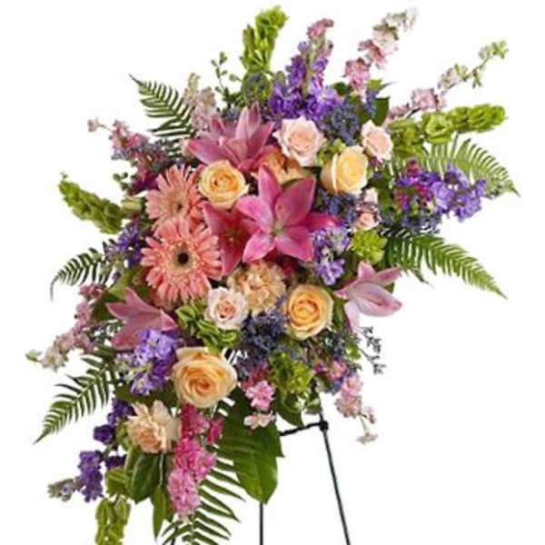 Standing floral spray with pink lilies, roses, and purple flowers