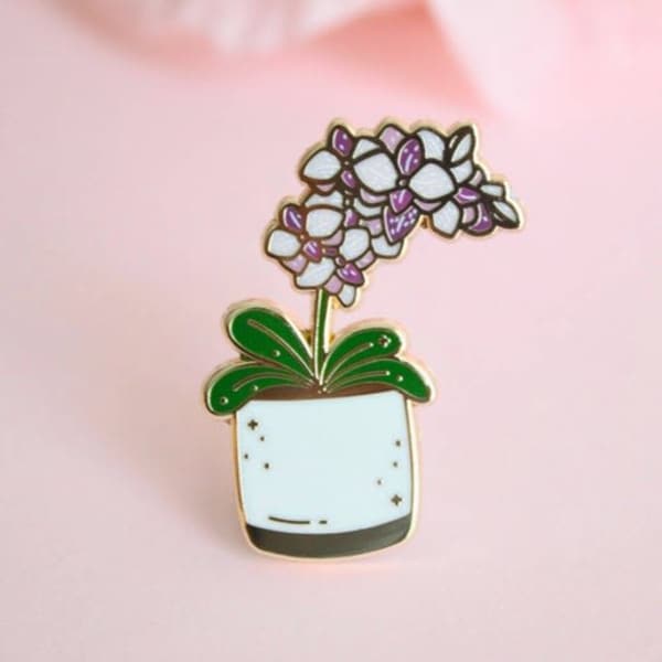 Enamel pin of a potted purple and white flower