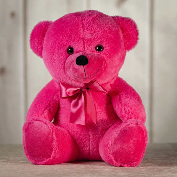 Bright pink teddy bear with a satin ribbon bow
