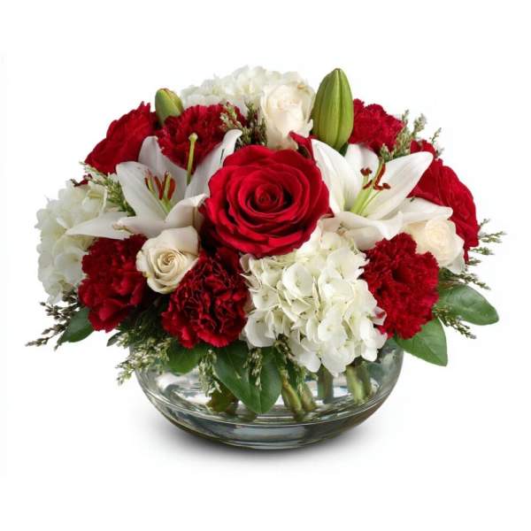 Red roses and white lilies arranged in a glass bowl vase