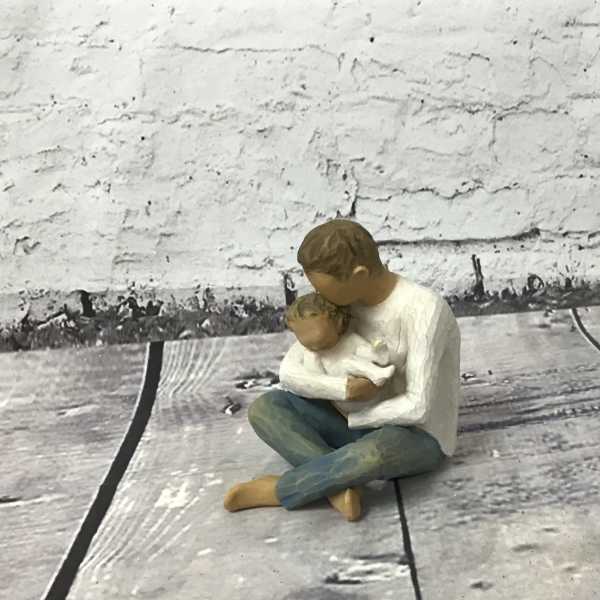 Small figurine of a person holding a child