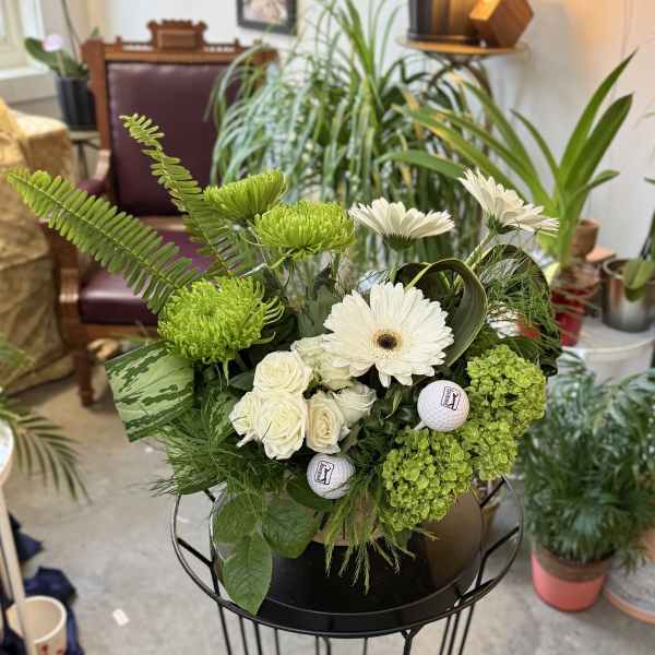 White gerbera daisies and roses with green blooms in a black container