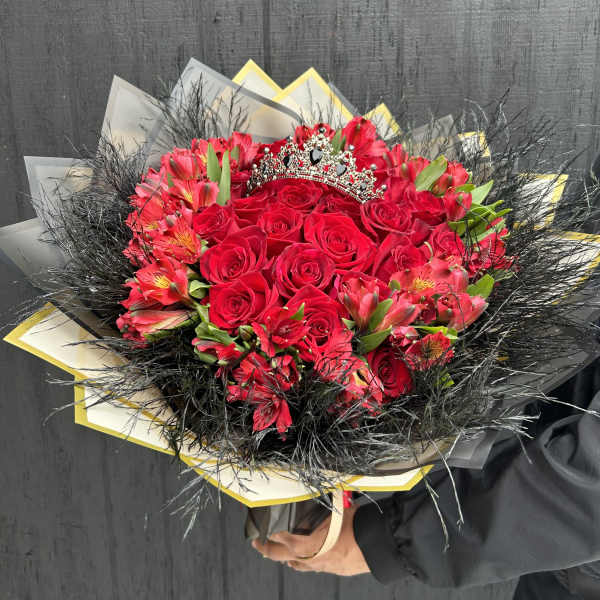 Bouquet of red roses and pink alstroemeria with a jeweled tiara